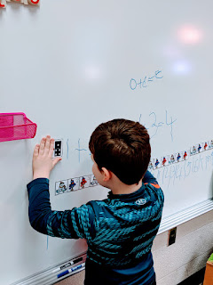 writing on white board  for math centers teach magically